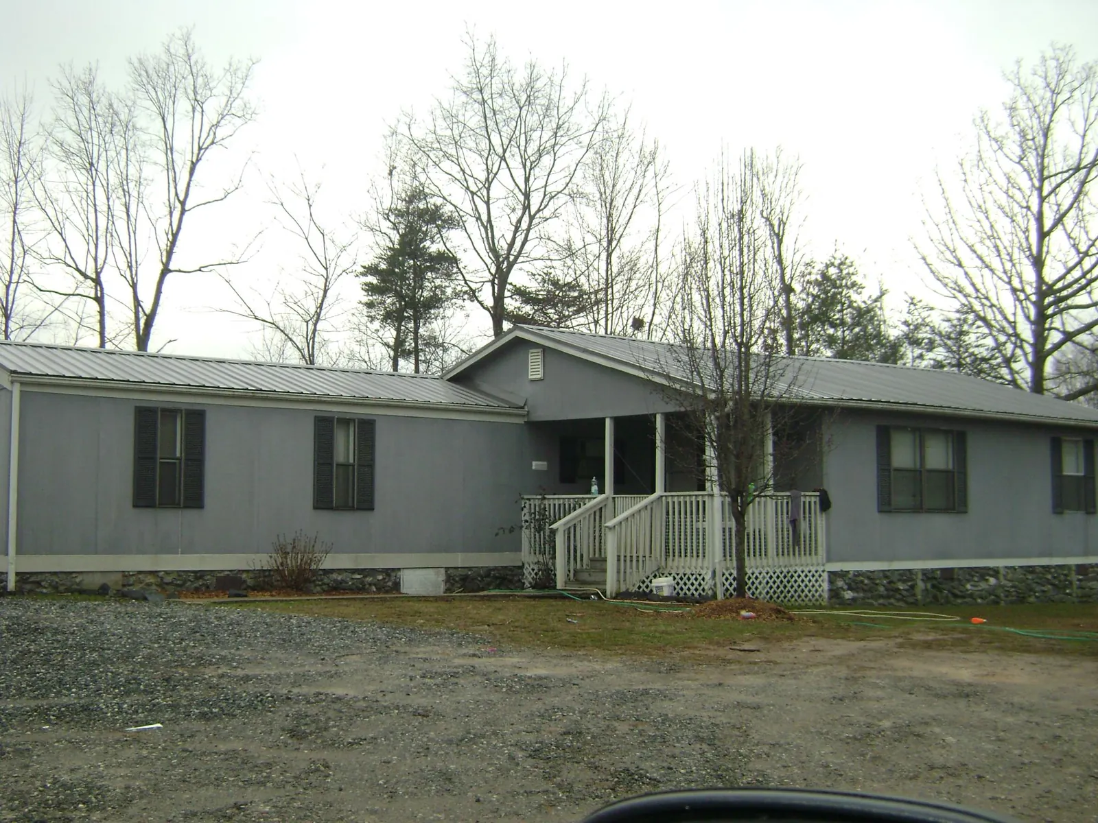 Metal roof over a manufactured home with a covered front porch in Schererville