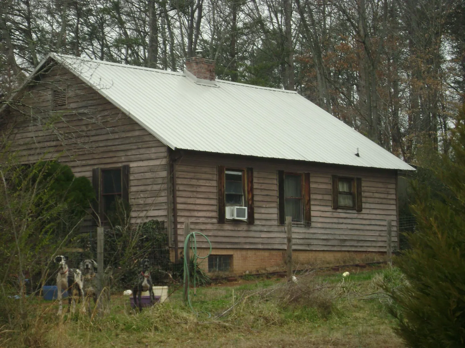 White metal roof on an old wood sided farmhouse, from a Metal Roof Installation job in Schererville